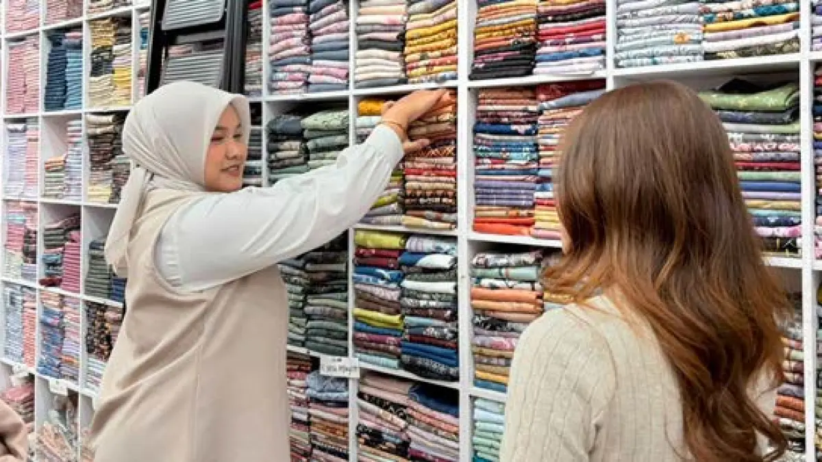 BANYAK PILIHAN: Seorang konsumen mendengarkan penjelasan produk hijab di Cantix Gajayana, Lowokwaru, pekan lalu.