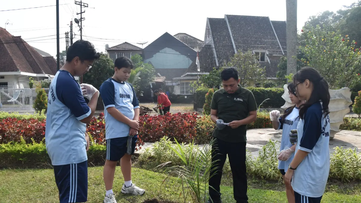 DIIRINGI DOA: Para murid dan guru memohon berkat sebelum menanam palem raja.