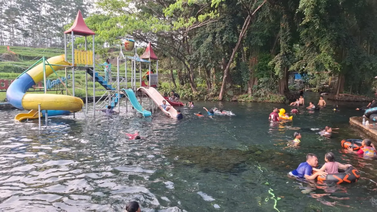 Sejumlah wisatawan menikmati kesegaran wahana air terjun Grojogan Sewu di kawasan objek wisata Wisata Sumber Maron, Desa Karangsuko, Kecamatan Pagelaran,Pada momen libur HUT Ke-81 RI (17/8). (Ramizard Rafsanjani/Radar Malang)