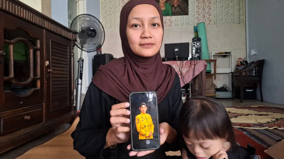 Istri Topan Srimulat menunjukkan foto sang suami. (Ramizard Rafsanjani/Radar Malang)