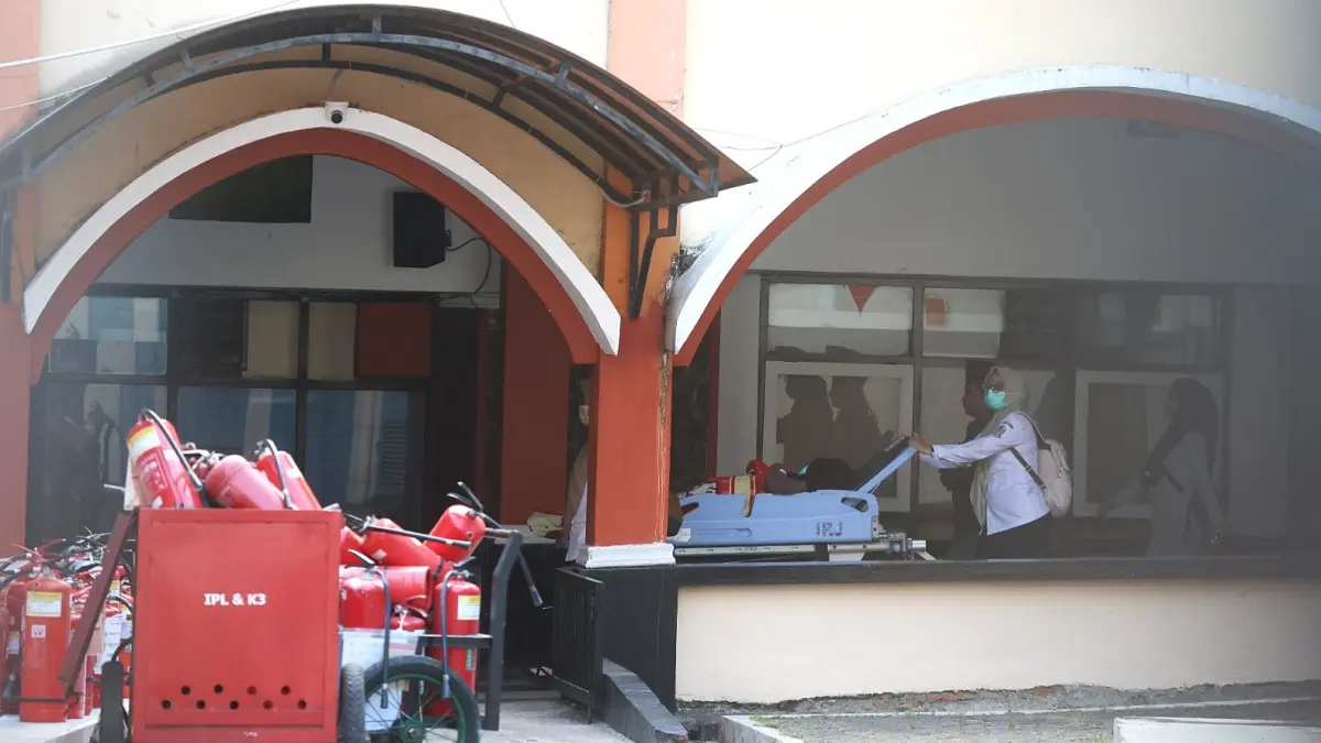 PLAFON RUSAK DAN ROBOH: Salah satu pasien dievakuasi menuju ruangan lain yang tidak terdampak kebakaran. (Darmono/Radar Malang)