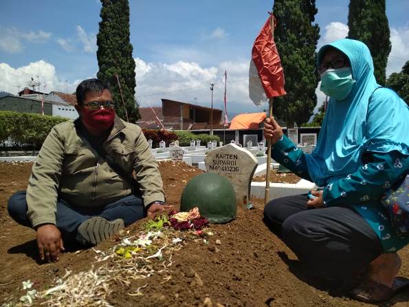 Salah satu peziarah mendoakan almarhum yang dimakamkan di TMP Kota Batu, Selasa (10/11). (Imam Nasrodin/Radar Malang)