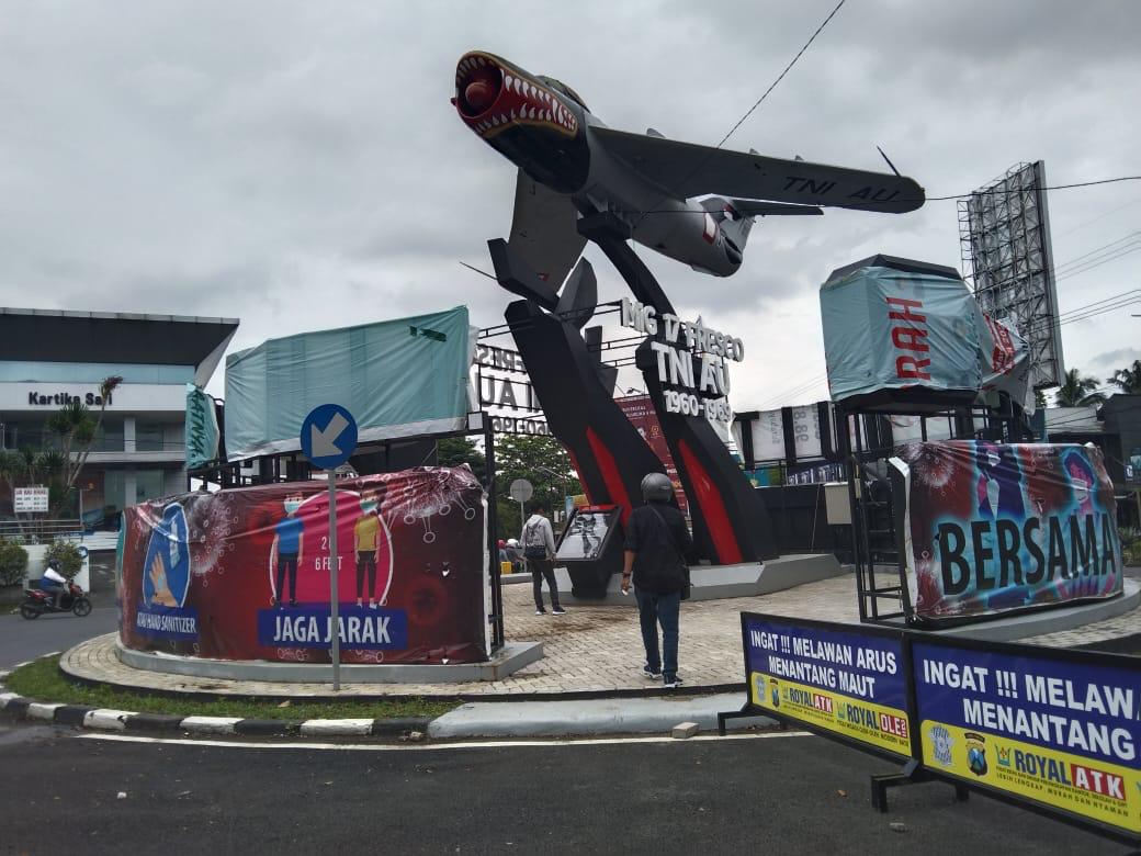 Reklame di monumen pesawat yang ditutup dengan banner .(Arlita ulya / Radar Malang)