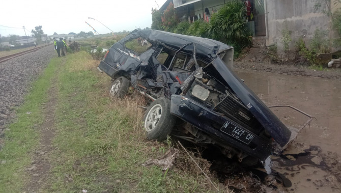 Kondisi mobil yang tertabrak kereta api di Desa Sonotengah, Kecamatan Pakisaji ringsek berat. (Darmono/Radar Malang)