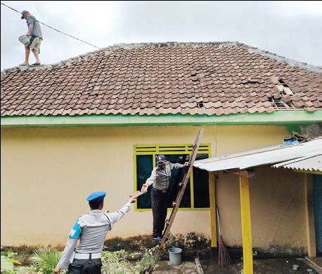 Personel dari Polsek Bantur membantu warga memperbaiki rumah korban gempa.  (ist)