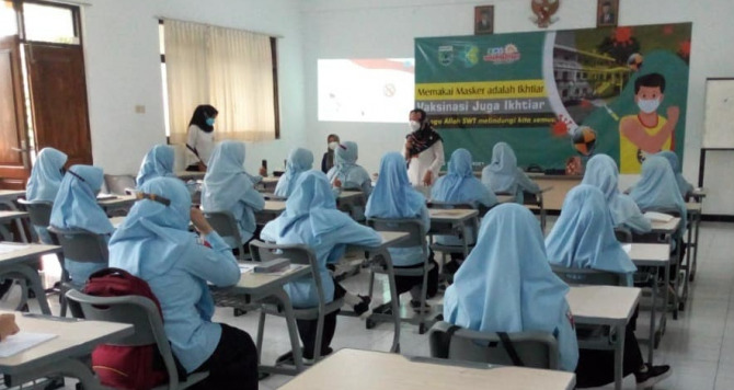 SAMBUT PTM: Dinkes ketika melakukan sosialisasi prokes di  SD Muhammadiyah 4 Kota Batu pada 6 Oktober lalu.