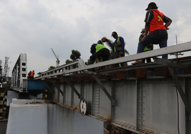 Sejumlah pekerja saat melakukan penggantian kayu bantalan rel kereta di jembatan kawasan Jalan Trunojoyo, Kiduldalem, Kota Malang Kamis (28/10). (Darmono/Radar Malang)
