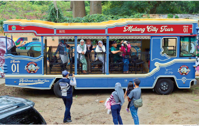 TAMBAH TITIK PEMBERHENTIAN: Penumpang bus Macito berpose untuk mengabadikan momen. Dishub dalam waktu dekat segera menambah satu titik pemberhentian. (Darmono/Radar Malang)