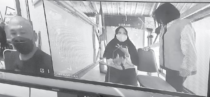 PASRAH: Nurbayani Rahangiar (berkerudung) mengikuti sidang via zoom di PN Kota Malang, kemarin. Dia dihukum tujuh bulan penjara. (BIYAN MUDZAKY HANINDITO / RADAR MALANG)