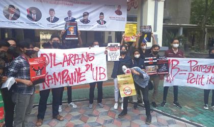 TOLAK POLITISI: Para mahasiswa UB memprotes kebijakan kampus yang mengundang menteri sekaligus ketua parpol.