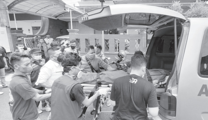 KOMPLIKASI: Warga dan relawan mengevakuasi jenazah Imanuel Tangkesalu dari rumah kos di Jalan Jambu, Kelurahan Bareng, Kecamatan Klojen, kemarin.  (BIYAN MUDZAKY HANINDITO / RADAR MALANG)