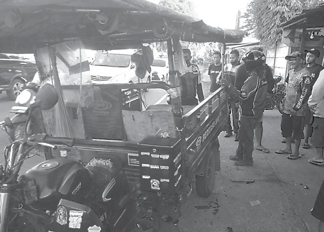 BARANG BUKTI: Polisi dan warga mengamati motor roda tiga yang terlibat kecelakaan di Jalan Raya Adi Mulyo, Dusun Watudakon, Desa Kendalpayak, kemarin (19/12).