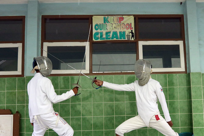TERBIASA NOMADEN: Dua atlet anggar Kabupaten Malang berlatih di halaman salah satu kelas di SMP Negeri 2 Jabung, kemarin sore (16/2). (Darmono / Radar Malang)