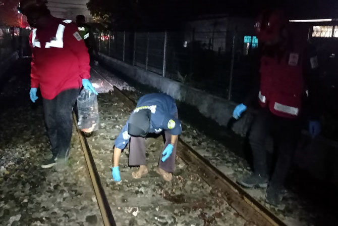 PUNGUT : Relawan Kota Malang memungut organ tubuh dan daging manusia yang tercerai-berai usai tertabrak kereta api di perlintasan Kebonsari Sukun. (Relawan Kota Malang for Radar Malang)