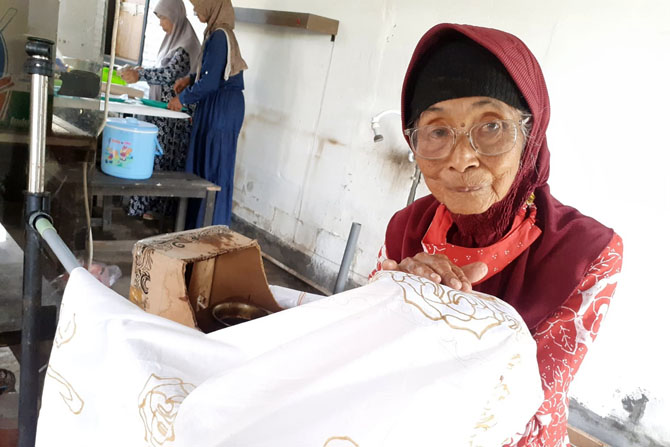 PELESTARI BATIK: Tati Soephihajarniwati menunjukkan cara membatik di gedung Karang Wreda Pandu Dewanata, Desa Randuagung, Kecamatan Singosari kemarin. (Indah Mei Yunita/Radar Malang)