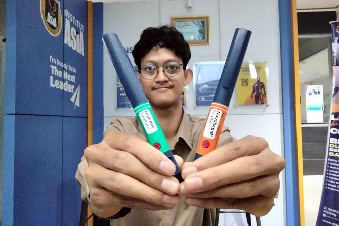 LEBIH PERCAYA DIRI: Bintang Reyhan Bimantoro menunjukkan dua alat suntik insulin yang selalu dia bawa setiap hari.(Nabila Amelia / Radar Malang)
