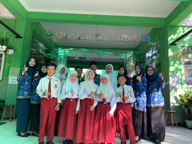 BERPRESTASI : Kepala Sekolah Drs Priyo Hadi Wijayanto MPd bersama guru pendamping lomba dan siswa, di halaman SDN Purwantoro 1 Malang.