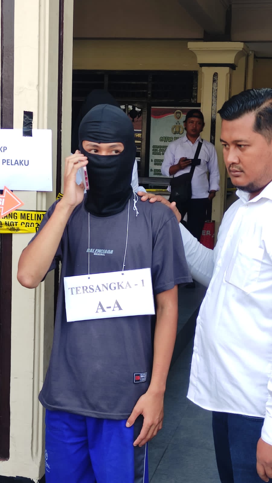 ADEGAN PENTING: Pelaku anak, AA tampak memeragakan adegan bertelefon saat rekonstruksi.