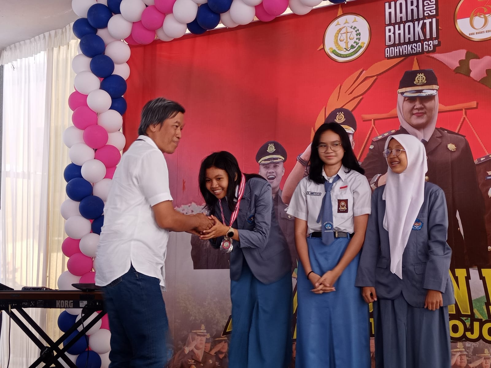 PENYERAHAN HADIAH: Direktur Jawa Pos Radar Mojokerto M. Nur Kholis (baju putih) menyerahkan hadiah kepada juara kedua lomba basket 3x3 kategori pelajar putri ajang Kajari Cup.