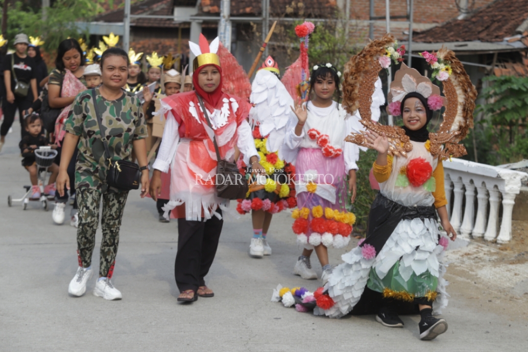 BERAGAM: Siswa SDN Pulorejo 1, Kecamatan Dawarblandong antusias mengikuti kirab Hari Pahlawan dengan pakaian ala pejuang, pakaian adat dan berbahan daur ulang.