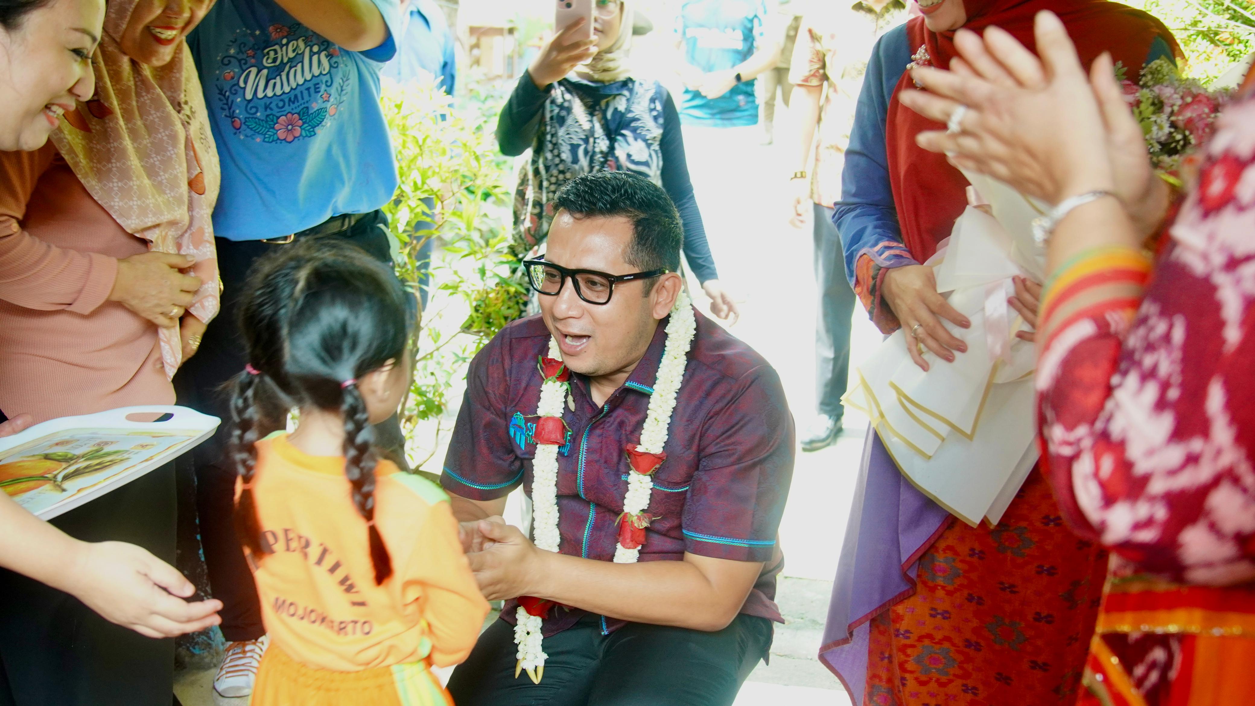 RAMAH: Pj Wali Kota Mojokerto Moh. Ali Kuncoro disambut salah satu anak didik dengan pengalungan bunga saat berkunjung ke TK Pertiwi.