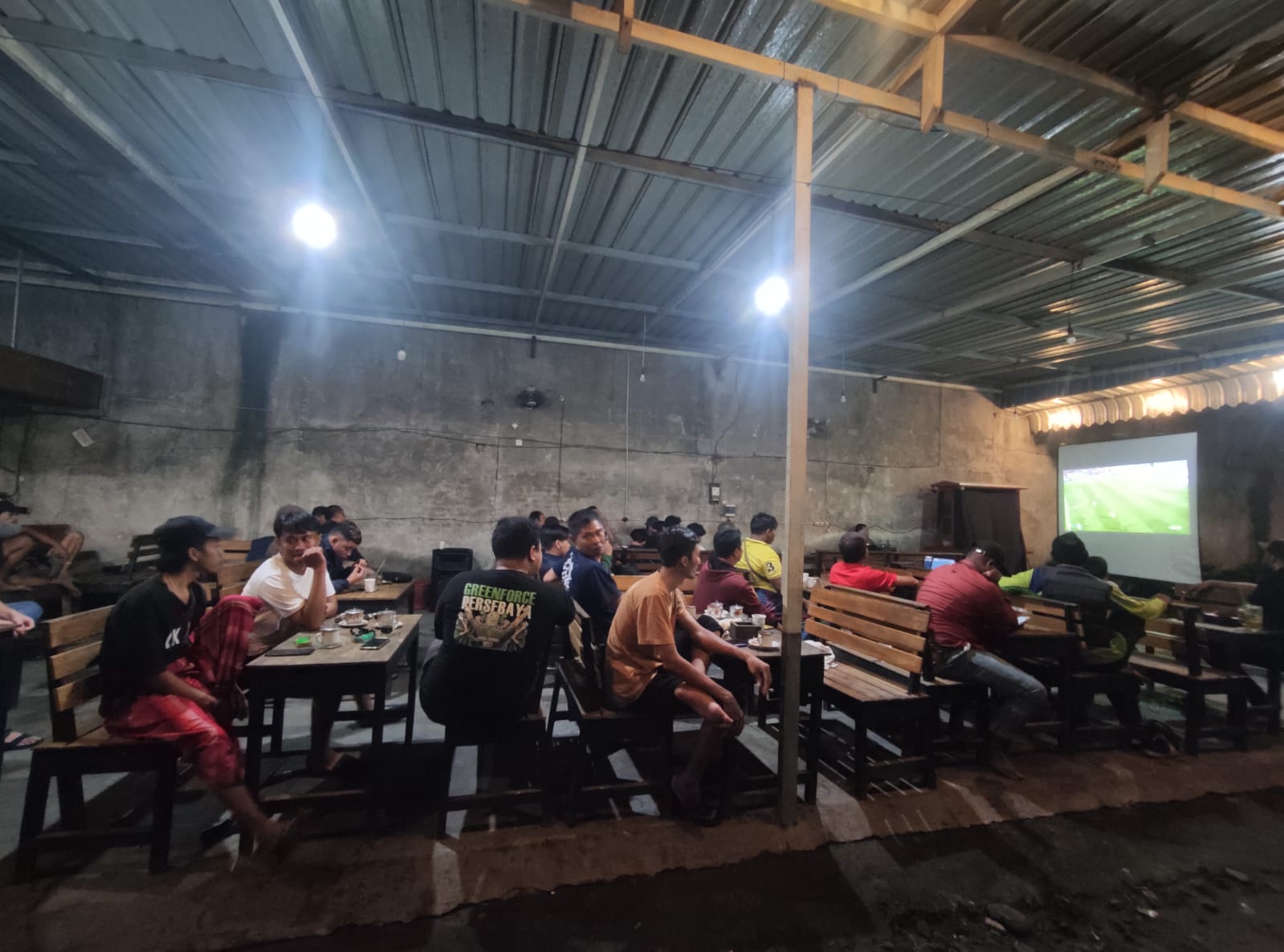 SEMARAK: Suasana nobar Piala Asia 2024 U-23 yang digelar Jawa Pos Radar Mojokerto dengan PS Mojokerto Putra di warkop Bungsu, Minggu (22/4/2024).