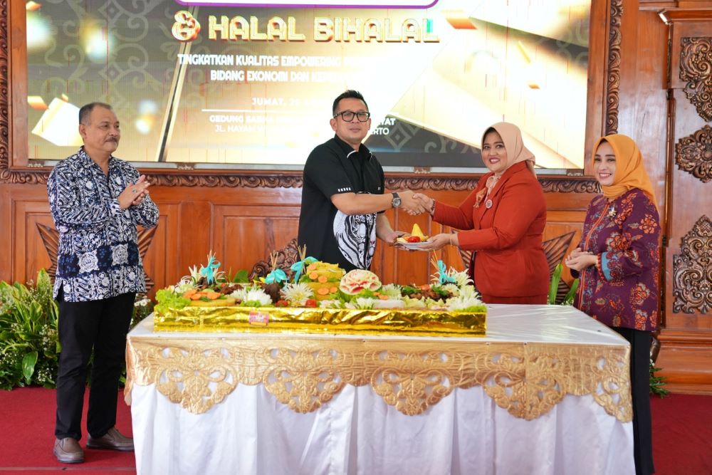 HARI ULANG TAHUN: Pj Wali Kota Mojokerto Moh. Ali Kuncoro didampingi Ketua TP PKK Nia Wayanti Ali Kuncoro (kanan) memberikan potongan tumpeng kepada Ketua GOW Kota Mojokerto Dewi Ratna Wati Gaguk,