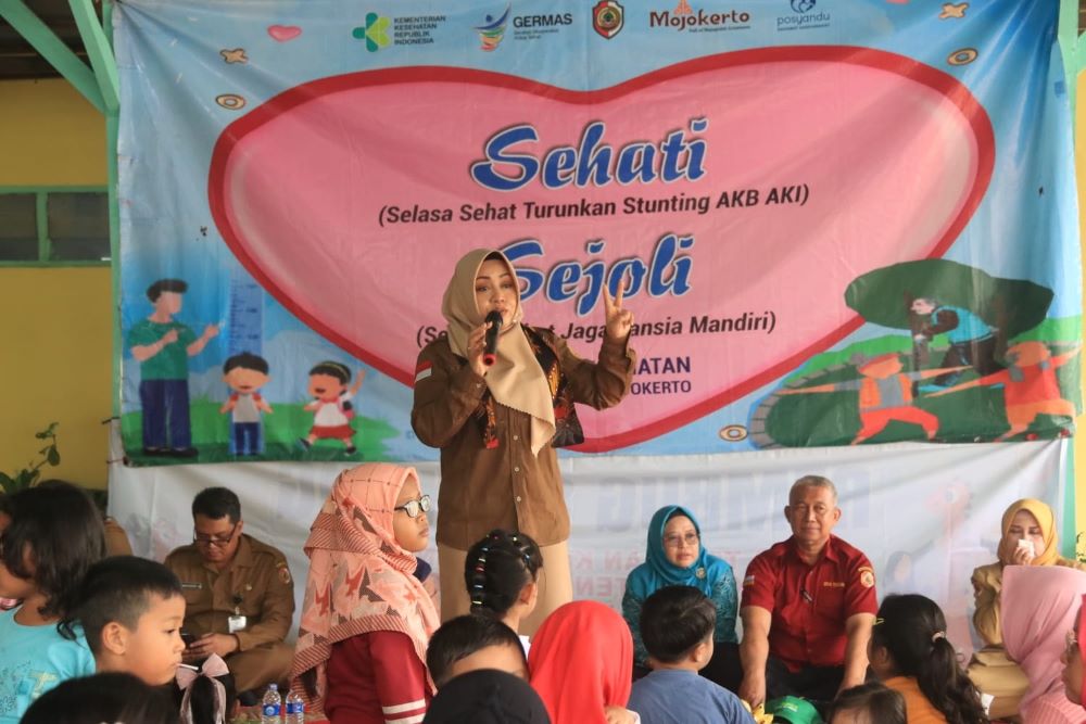 BERI EDUKASI: Bupati Ikfina Fahmawati bersemangat menjelaskan stunting dan pola hidup sehat kepada masyarakat di pendapa Balai Desa Terusan, Kecamatan Gedeg, Selasa (2/7).