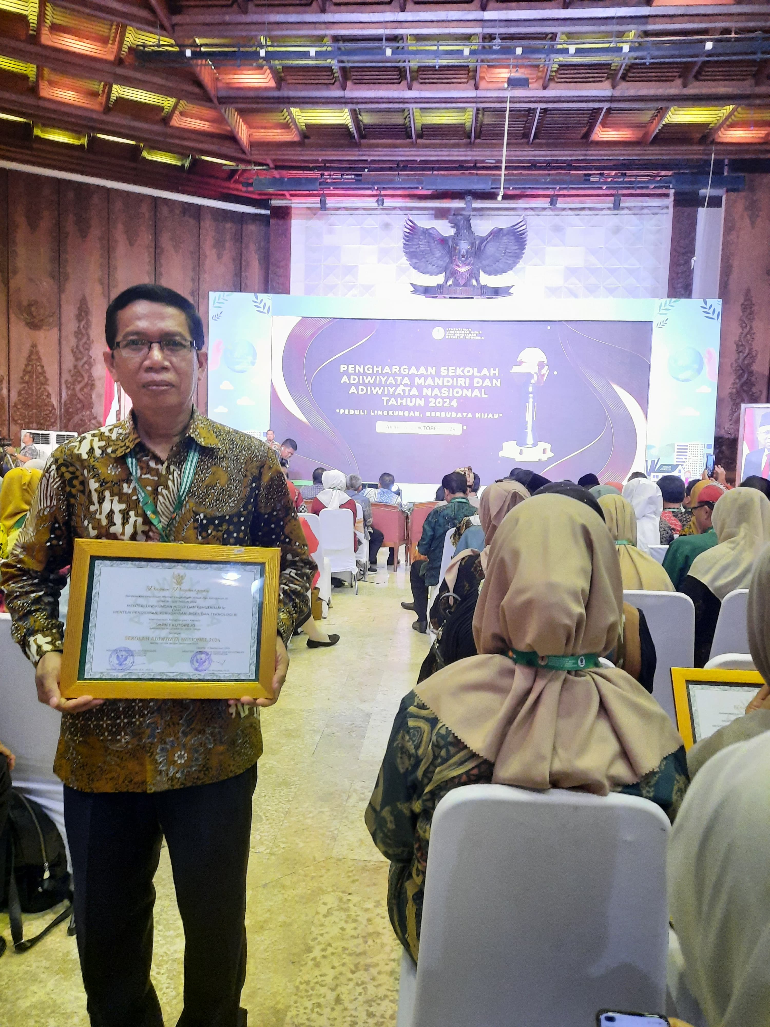 RAIH PENGHARGAAN: Kepala SMPN 1 Kutorejo, Drs Supriyadi, SE, M.Pd membawa pulang piagam penghargaan sekolah Adiwiyata Nasional dari Kementerian Lingkungan Hidup dan Kehutanan RI.