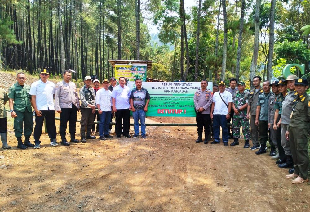DISEGEL: Petugas Perhutani bersama Forkopimca Pacet menyegel pintu masuk Wisata Alam Sari di Desa Nogosari, Kecamatan Pacet, Senin (11/11).