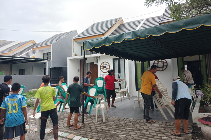 BERHARAP CEMAS: Warga menata tenda dan kursi di rumah duka korban yang belum terevakuasi di Perumahan The Suam Residence, Kelurahan Kedundung, Kecamatan Magersari, Kota Mojokerto, Selasa (28/1) petang