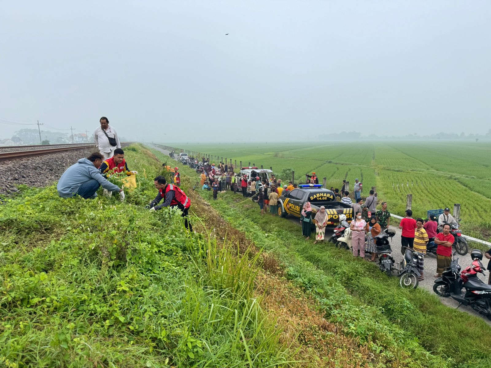 TRAGIS: Petugas melakukan olah TKP dan mengevakuasi jasad korban di sekitar rel KA, Desa Karangkedawang, Kecamatan Sooko, Kabupaten Mojokerto, Jumat (14/2) pagi.&nbsp;