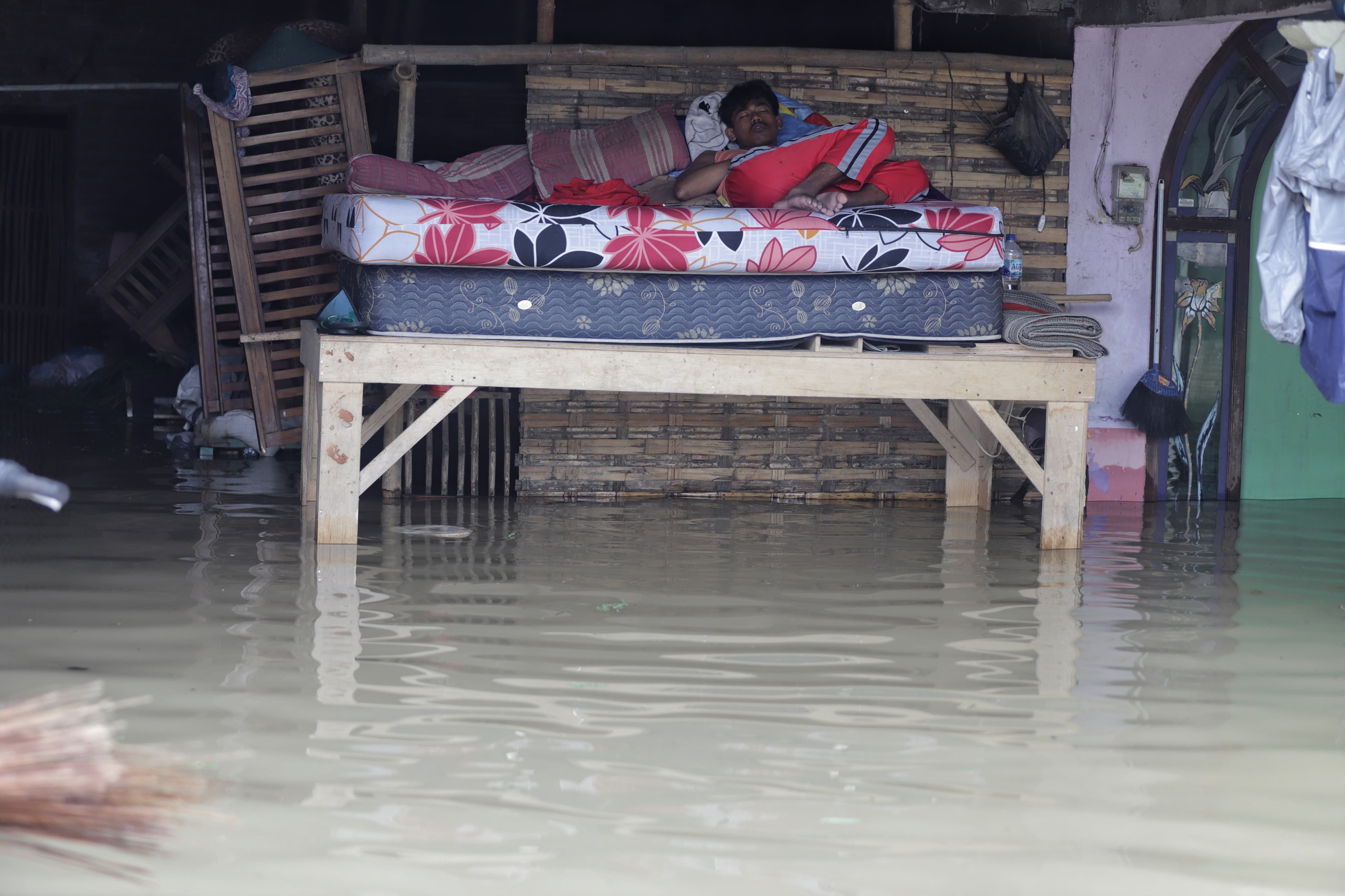 TERENDAM LAGI: Warga Dusun Klanting, Desa Pulorejo, Kecamatan Dawarblandong, Kabupaten Mojokerto beristirahat di tengah kepungan banjir, Sabtu (1/3).