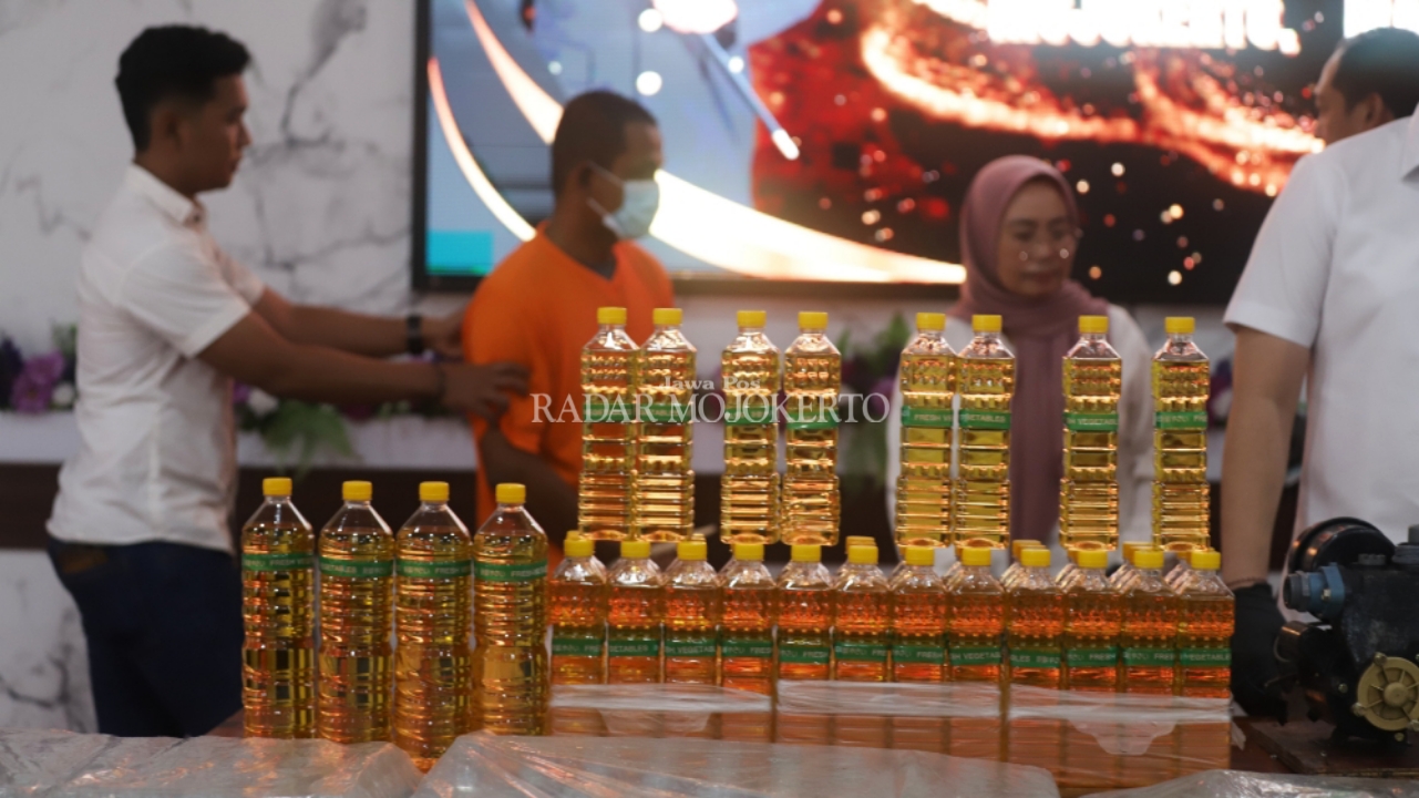 PEMBURU RENTE: Tersangka penjual minyak curah dalam kemasan dipamerkan saat pers rilis di Mapolres Mojokerto, Rabu (19/3).