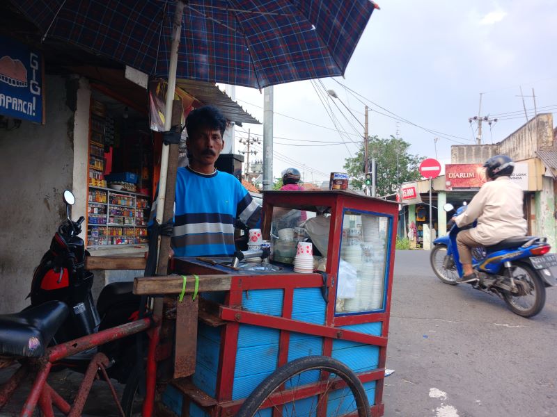 NELANGSA: Slamet Widodo dan gerobak es puter miliknya di simpang empat Jalan Prapanca, Kelurahan Mentikan, Kecamatan Prajurit Kulon, kemarin (14/4).