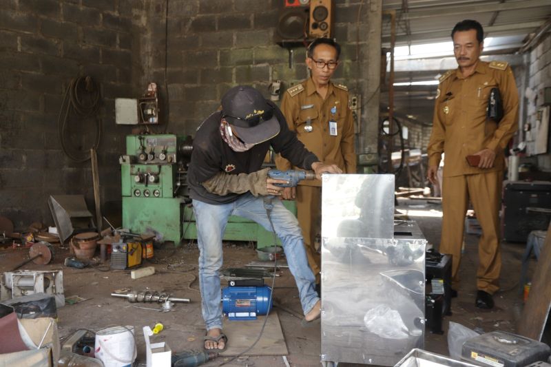 INOVATIF: Pemuda Desa Sumberwuluh, Kecamatan Dawarblandong, sedang memproduksi mesin roasting kopi pesanan pelanggan di Posyantek Sumber Oetoen.