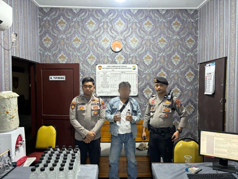 DITIPIRING: Petugas Satsamapta Polres Mojokerto Kota menangkap tersangka dan barang bukti miras ilegal, Sabtu (7/6).