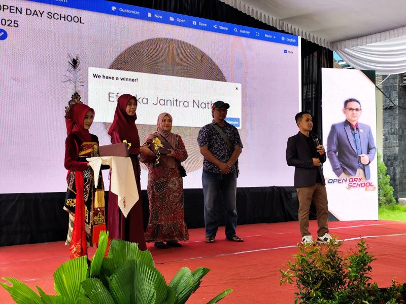 SEMRINGAH: Kepala SMK Mutia Ednan Rudianto membagikan sejumlah door prize bagi wali murid yang beruntung di kegiatan open school day, Minggu (6/7).