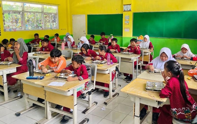 SESUAI TAKARAN: Siswa SDN Trowulan menyantap menu MBG saat jam istirahat, kemarin (29/8).