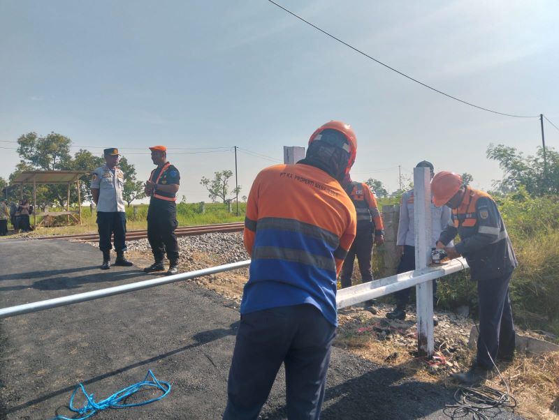 DARURAT: Petugas LLAJ DPRKP2 Kabupaten Mojokerto dan PT KAI memasang portal di perlintasan sebidang rel KA di Dusun Wonoayu, Desa Kepuhanyar, Kecamatan Mojoanyar beberapa waktu lalu.