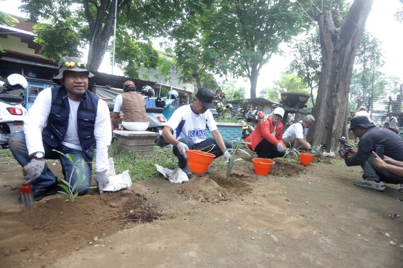 PENGHIJAUAN: Direktur Jawa Pos Radar Mojokerto M. Nur Kholis (dua dari kiri) melakukan penanaman pohon di kawasan Stadion Gajah Mada Mojosari, kemarin (25/10).
