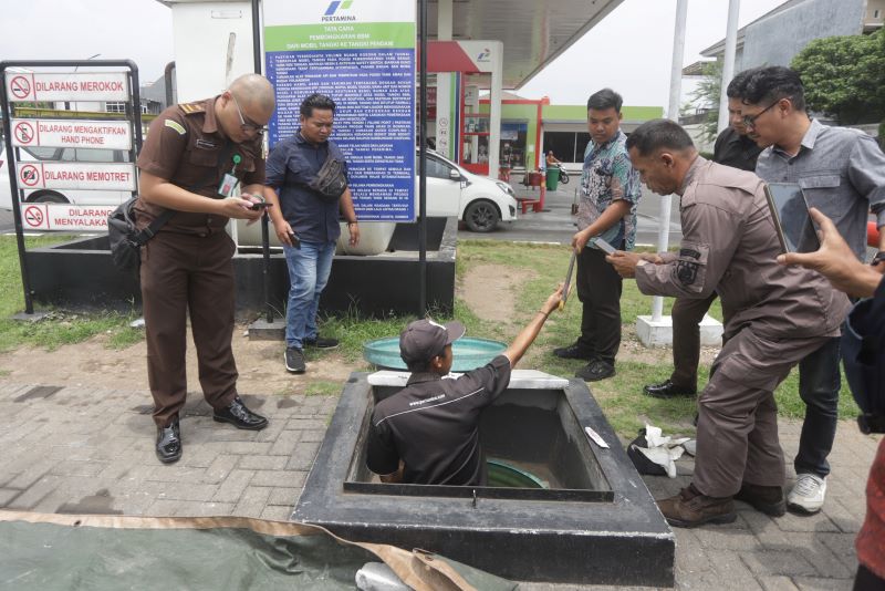 SESUAI STANDAR: Petugas gabungan dari diskopukmperindag, kejaksaan, dan Polres Mojokerto Kota saat mengecek sampel BBM jenis pertalite di SPBU, kemarin (28/10).