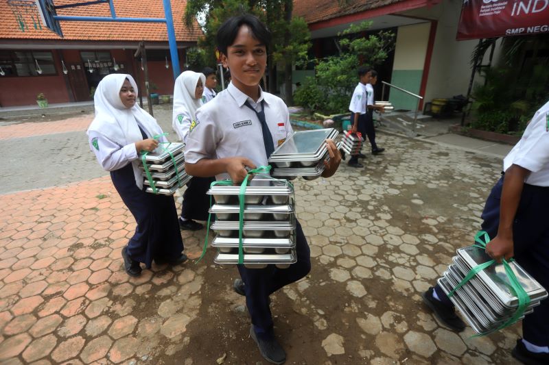 PAKET MBG: Siswa SMP di Kota Mojokerto tengah menyantap menu MBG beberapa waktu lalu.