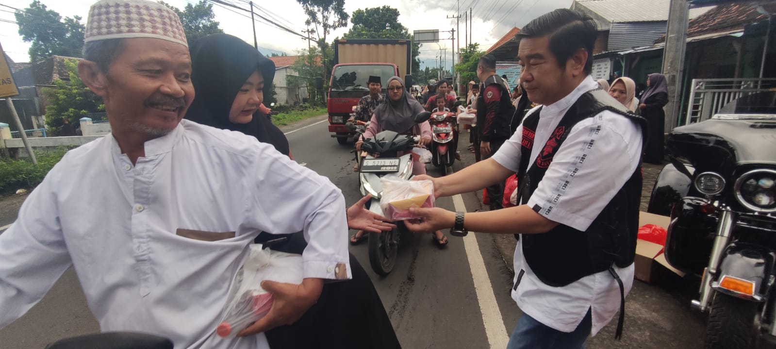 BERBAGI: Ketua Umum HDCI Mojokerto Raya, Soegianto membagikan sajian takjil kepada pengguna lalu lintas setempat, Kamis (5/3). 