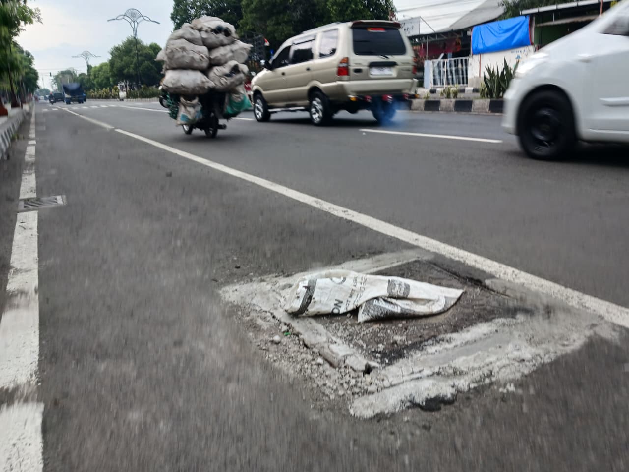 MEGAPROYEK: Kondisi Jalan Empunala, Kota Mojokerto, yang mengalami kerusakan pada besi penutup saluran air.
