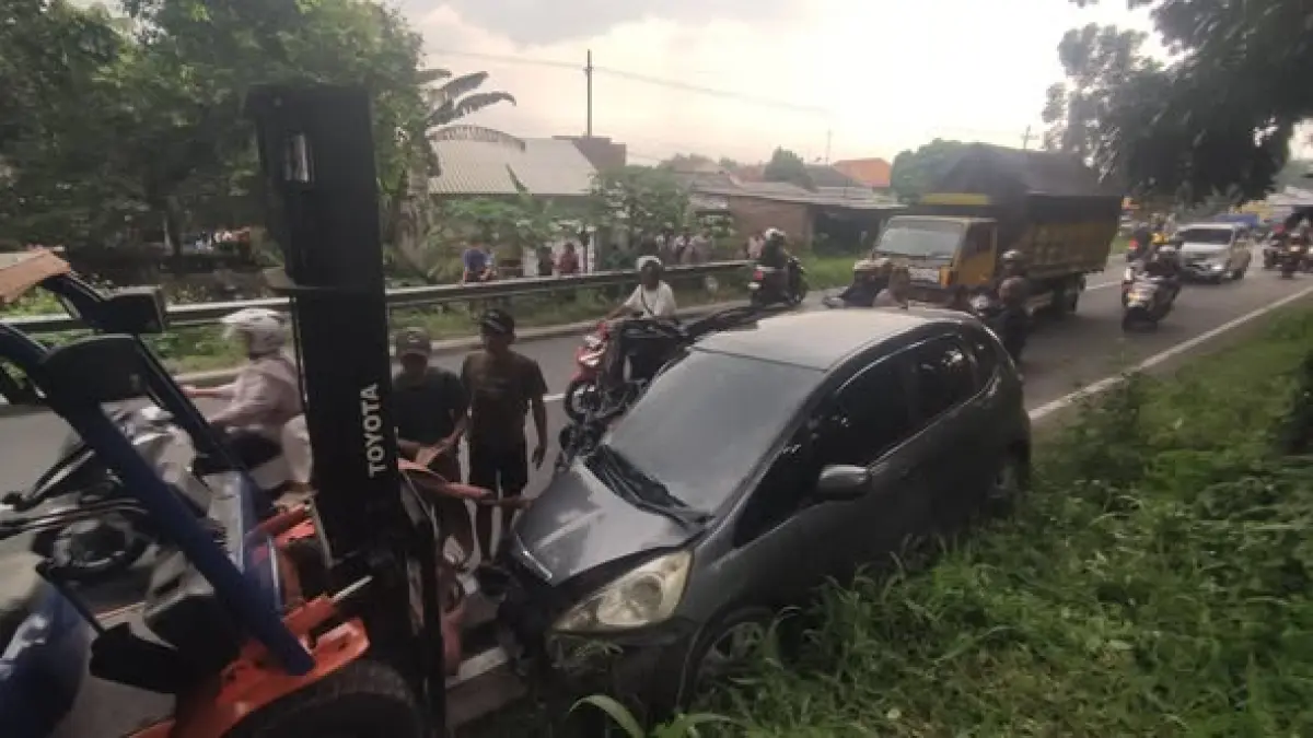DIDEREK: Mobil Jazz abu-abu yang terlibat kecelakaan di exit Tol Gedeg Mojokerto diderek ke Jalan Raya Gedeg, Kamis (2/4). (Arief JPRM)