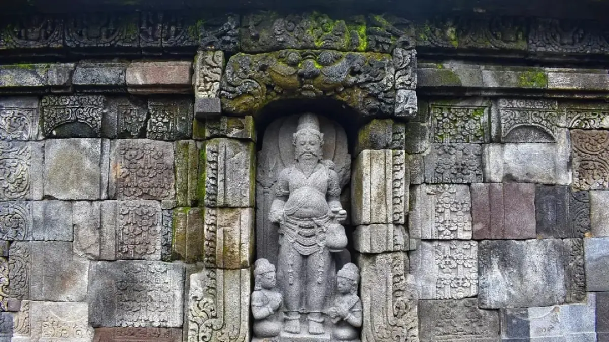 PENYEBAR ILMU: Relief Resi Agastya bersama figur pembawa lontar di dinding Candi Kedulan, Sleman, Yogyakarta.