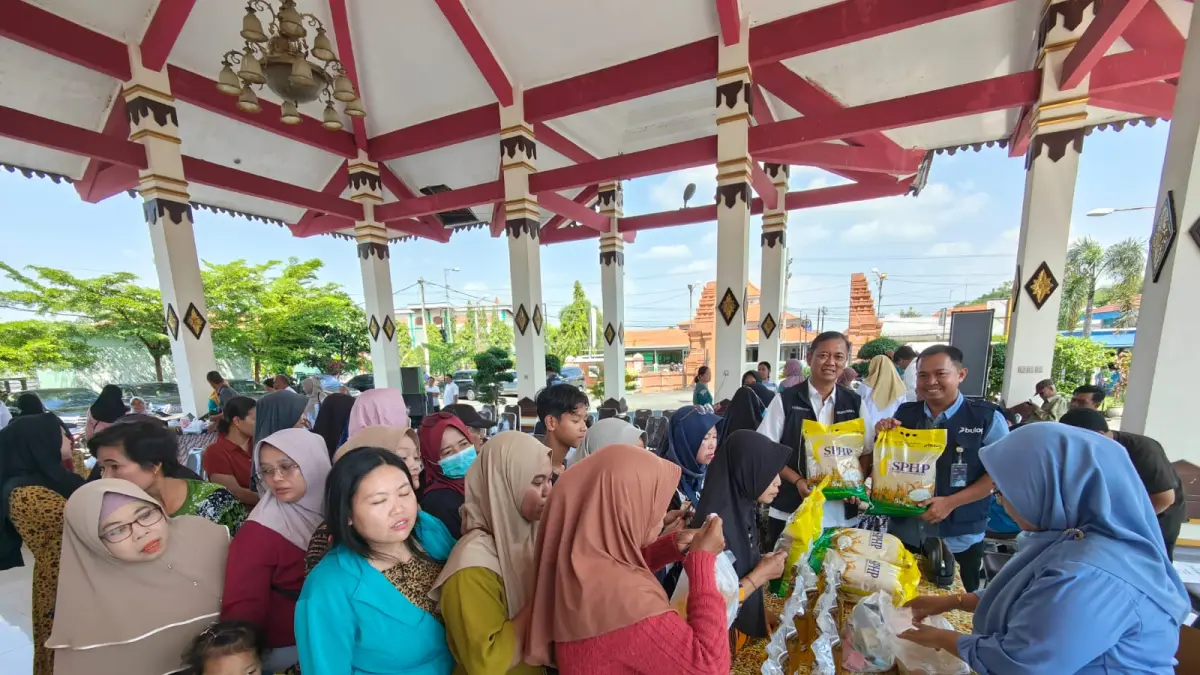 ANTUSIAS: Kepala Disperindag Kabupaten Mojokerto Noerhono bersama Pimpinan Bulog Mojokerto Muhammad Husin memantau antusiasme warga membeli beras yang disediakan PT PIM, kemarin (15/4).