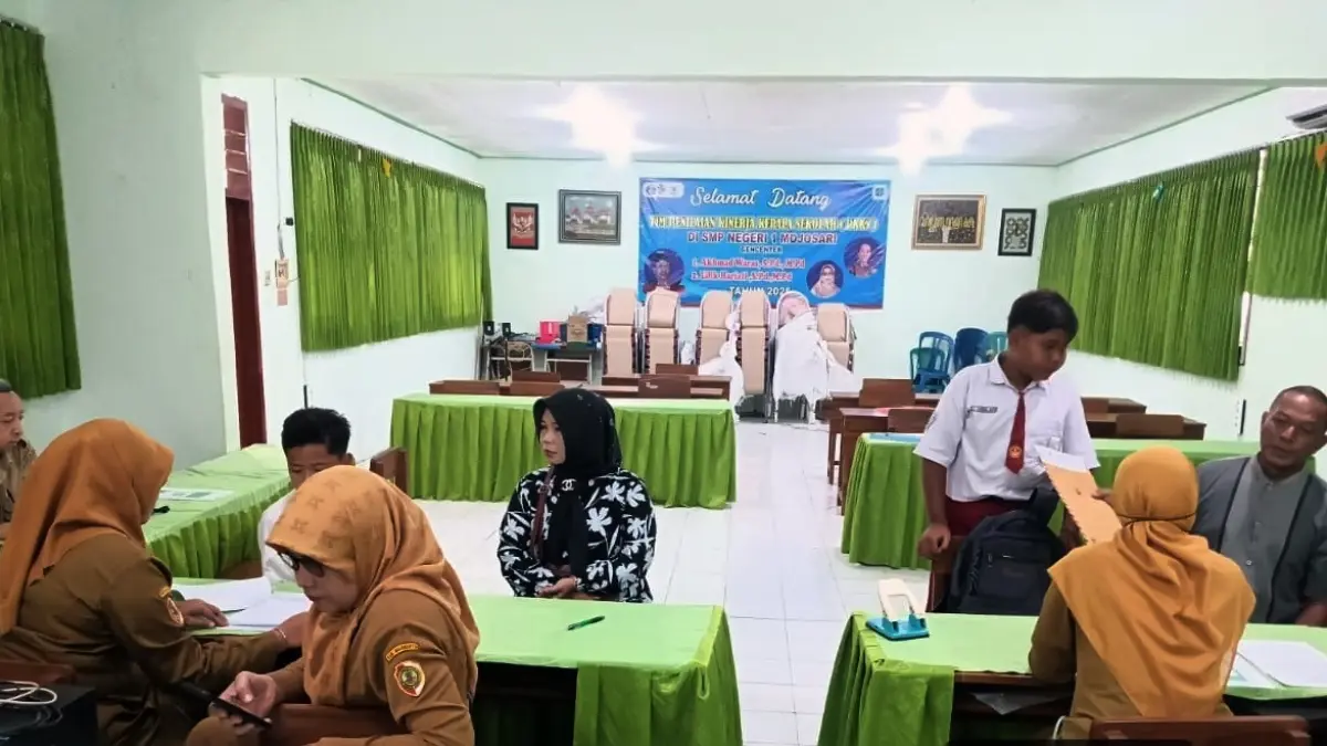LENGKAPI BERKAS: Calon siswa baru didampingi orang tua melakukan daftar ulang di SMPN 1 Mojosari usai dinyatakan lolos seleksi SPMB SMPN tahun ajaran 2026/2027 tahap pertama, kemarin (9/6). (Indah JPRM)
