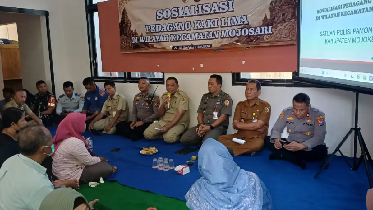 TAHAP SOSIALISASI: Kepala Satpol PP Kabupaten Mojokerto, M. Taufiqurrahman bersama Polres Mojokerto dan OPD terkait melakukan pendekatan dengan para PKL di Pendopo Kelurahan Sawahan, Kecamatan Mojosari, Selasa (23/6). (Khudori JPRM)